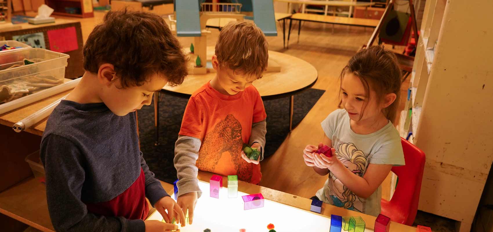 Children play with building blocks in classroom